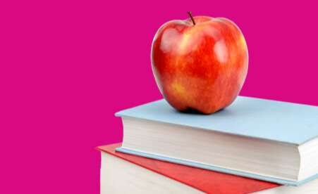 Image containing an apple on top of a stack of books